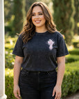 Woman wearing a black t-shirt with a logo outdoors