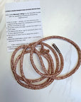 Rose gold rhinestone drawstring with instructions on a white background