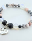 Bracelet with beads and 'Daughter' charm on a white background