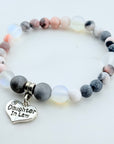 Bracelet with gray and white beads and a 'Daughter In Law' charm on a light background