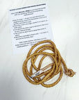 Gold drawstring with rhinestones and instructions on a white background