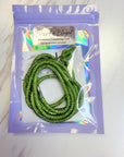 Green beaded cord in a clear plastic bag with a purple label on a white background