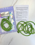 Green Rhinestone Cord with packaging and instructions on a white background