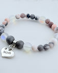 Beaded bracelet with 'Mom' charm on a light background