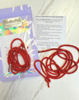 Red lanyard with a clear plastic packaging on a white background
