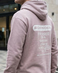 Person wearing a pink hoodie with a motivational message on the back.