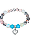 Multicolored beaded bracelet with a heart charm on a white background