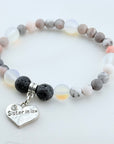 Beaded bracelet with a heart-shaped 'Sister in Law' charm on a light background