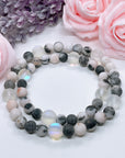 The 5 Second Rule Companion gemstone stretch bracelet made with pink zebra jasper beads and translucent aura beads sits on a white table. Natural neutral colors.