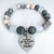Beaded bracelet with a heart-shaped charm on a white background