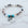 Beaded bracelet with heart-shaped charms on a marble background