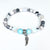 Bracelet with beads and angel wing charm on a white background