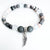 Bracelet with gray and white beads and a silver wing charm on a white background