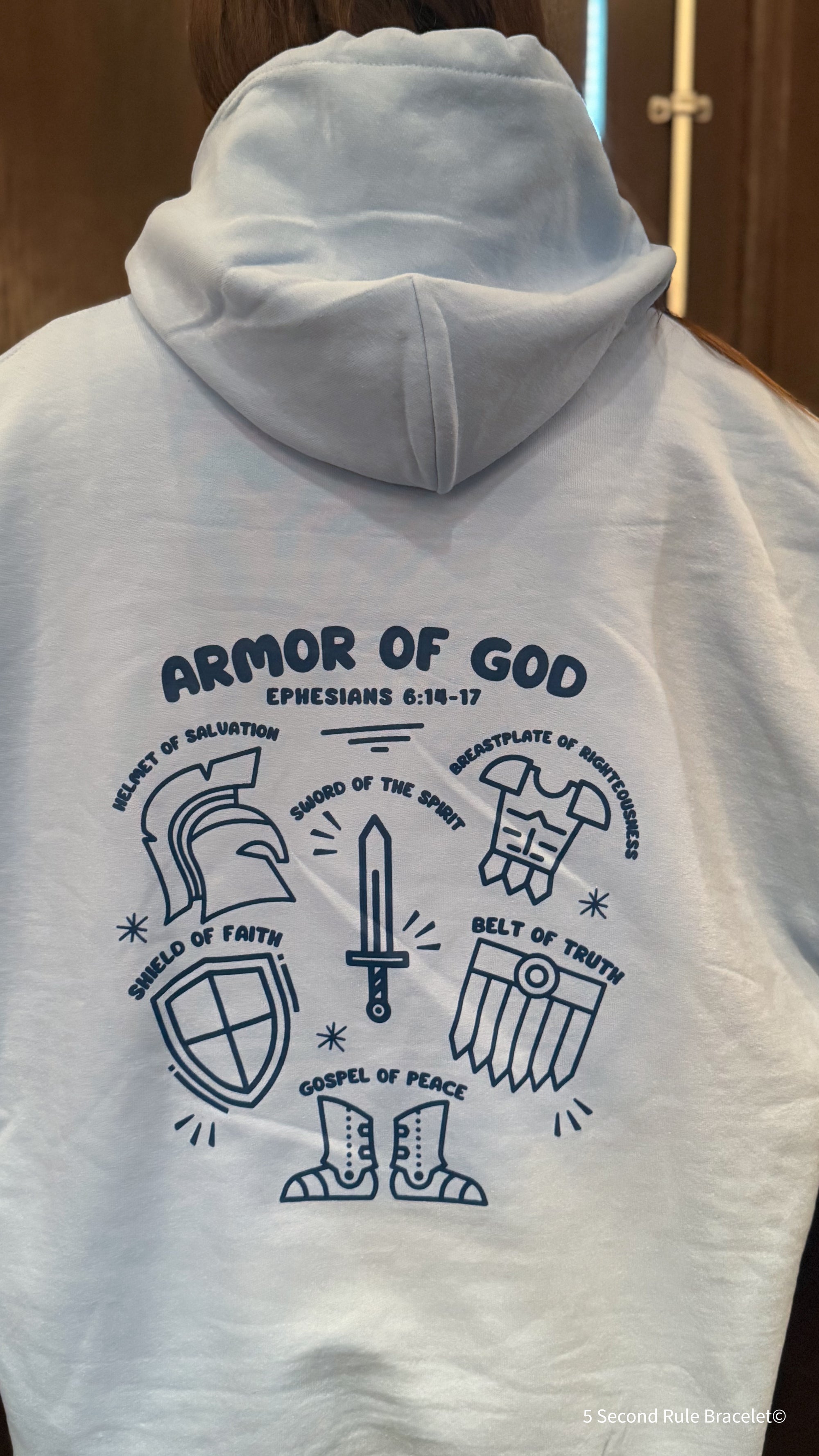 White hoodie with 'Armor of God' design on the back