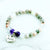 Beaded bracelet with a heart-shaped 'Aunt' charm on a white background