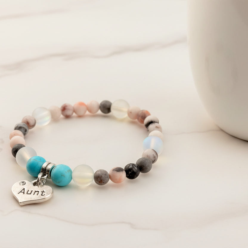 Beaded bracelet with a heart-shaped 'Aunt' charm on a light background