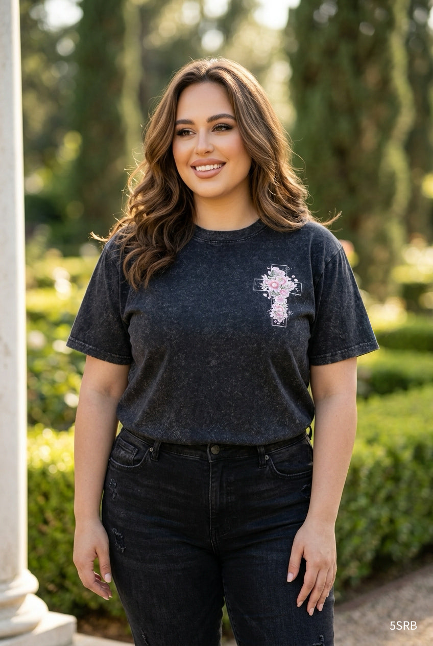 Woman wearing a black t-shirt with a logo outdoors
