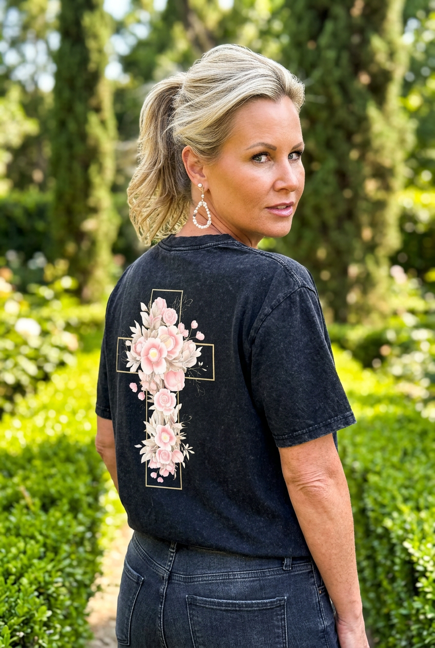 Woman wearing a black t-shirt with floral designs outdoors