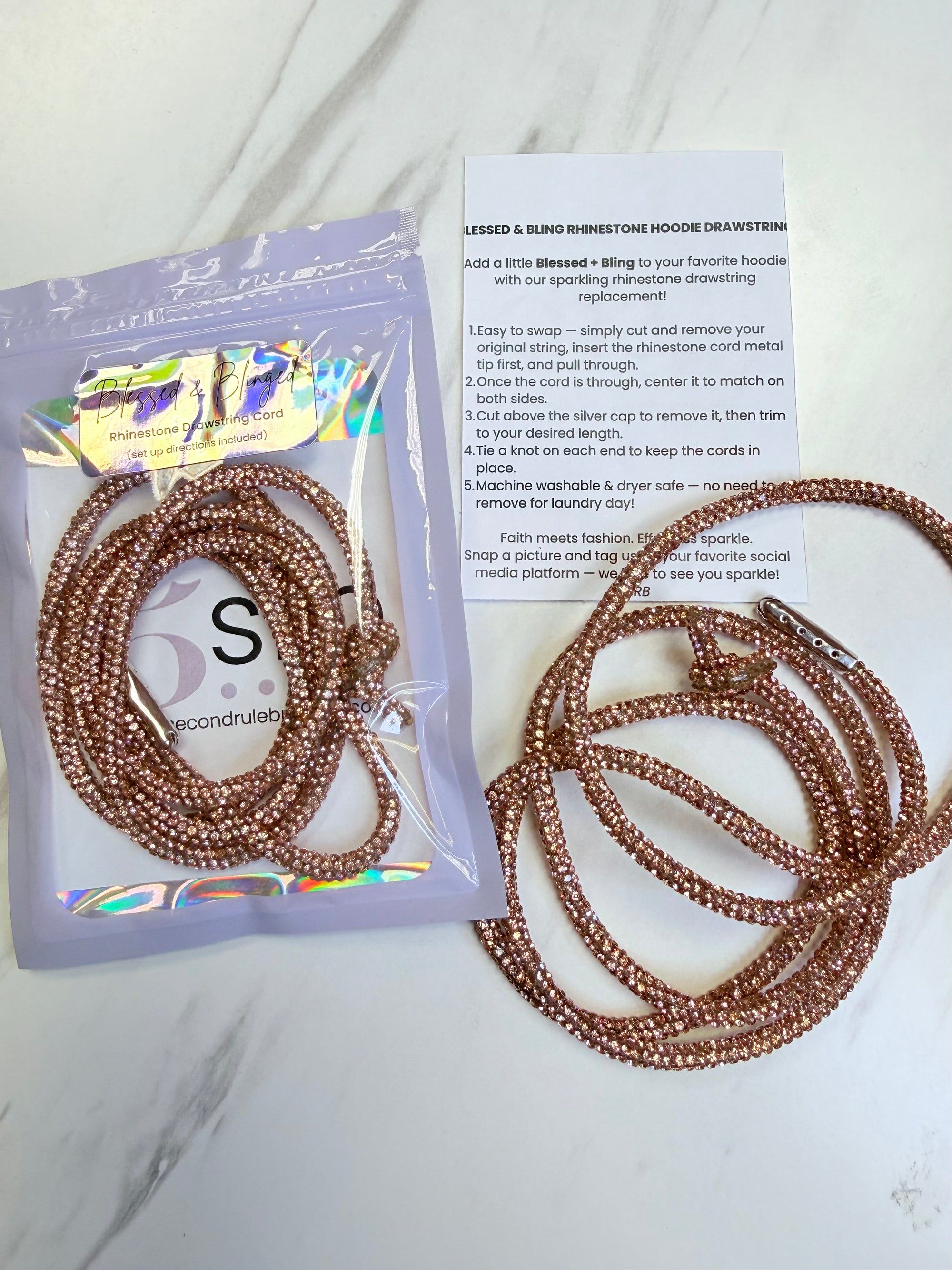 Set of beaded hair ties with packaging and instructions on a marble surface