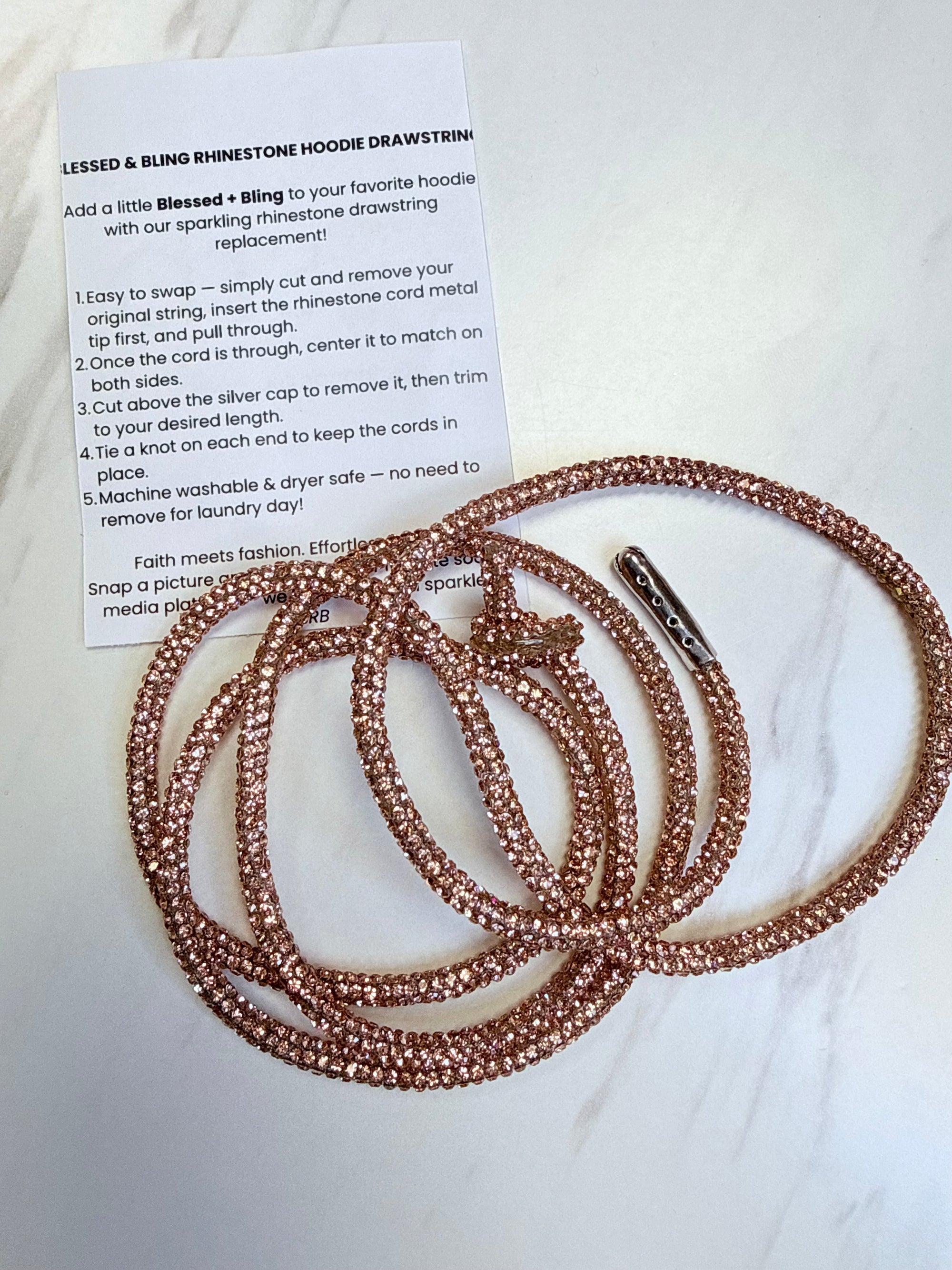 Rose gold rhinestone drawstring with instructions on a white background