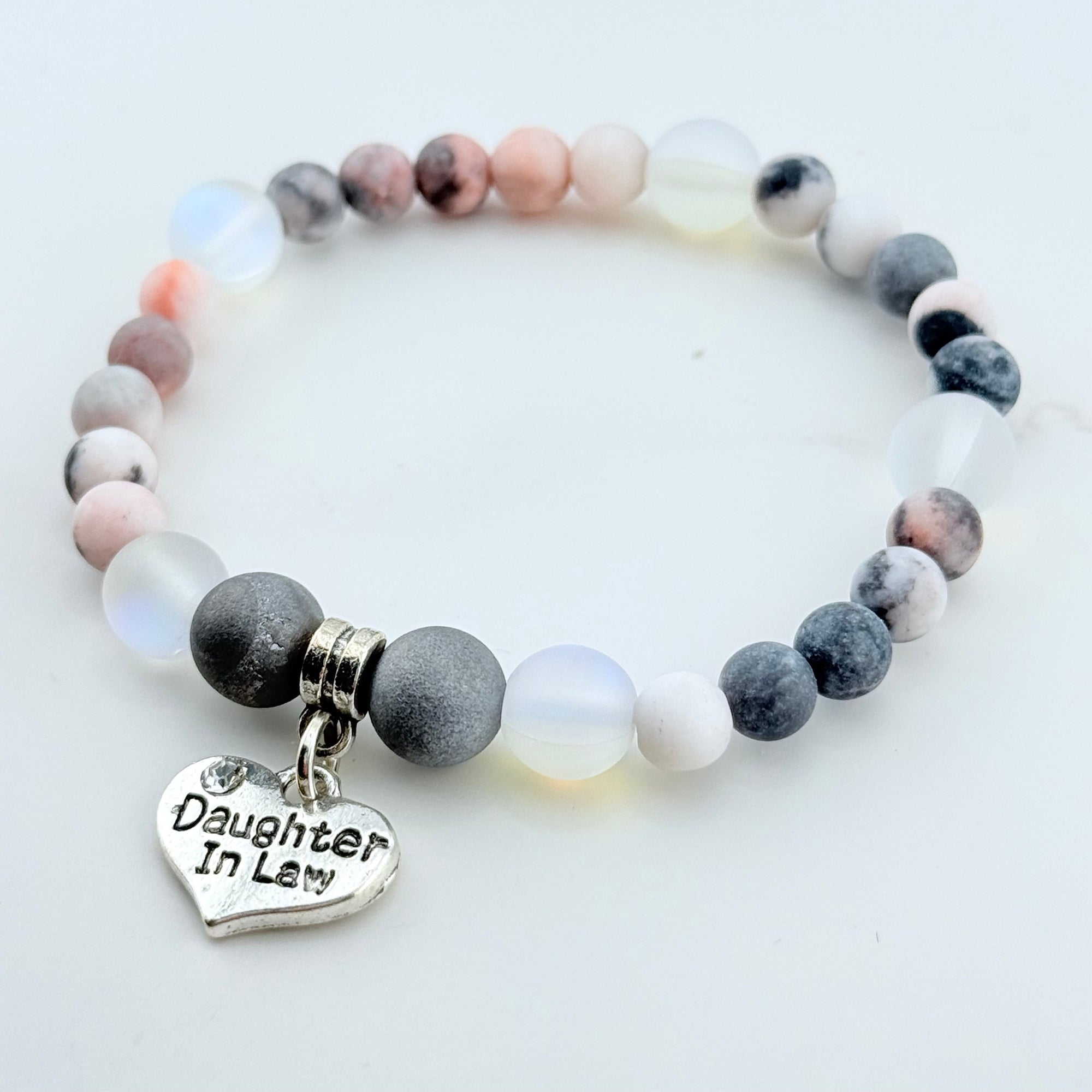Bracelet with gray and white beads and a 'Daughter In Law' charm on a light background