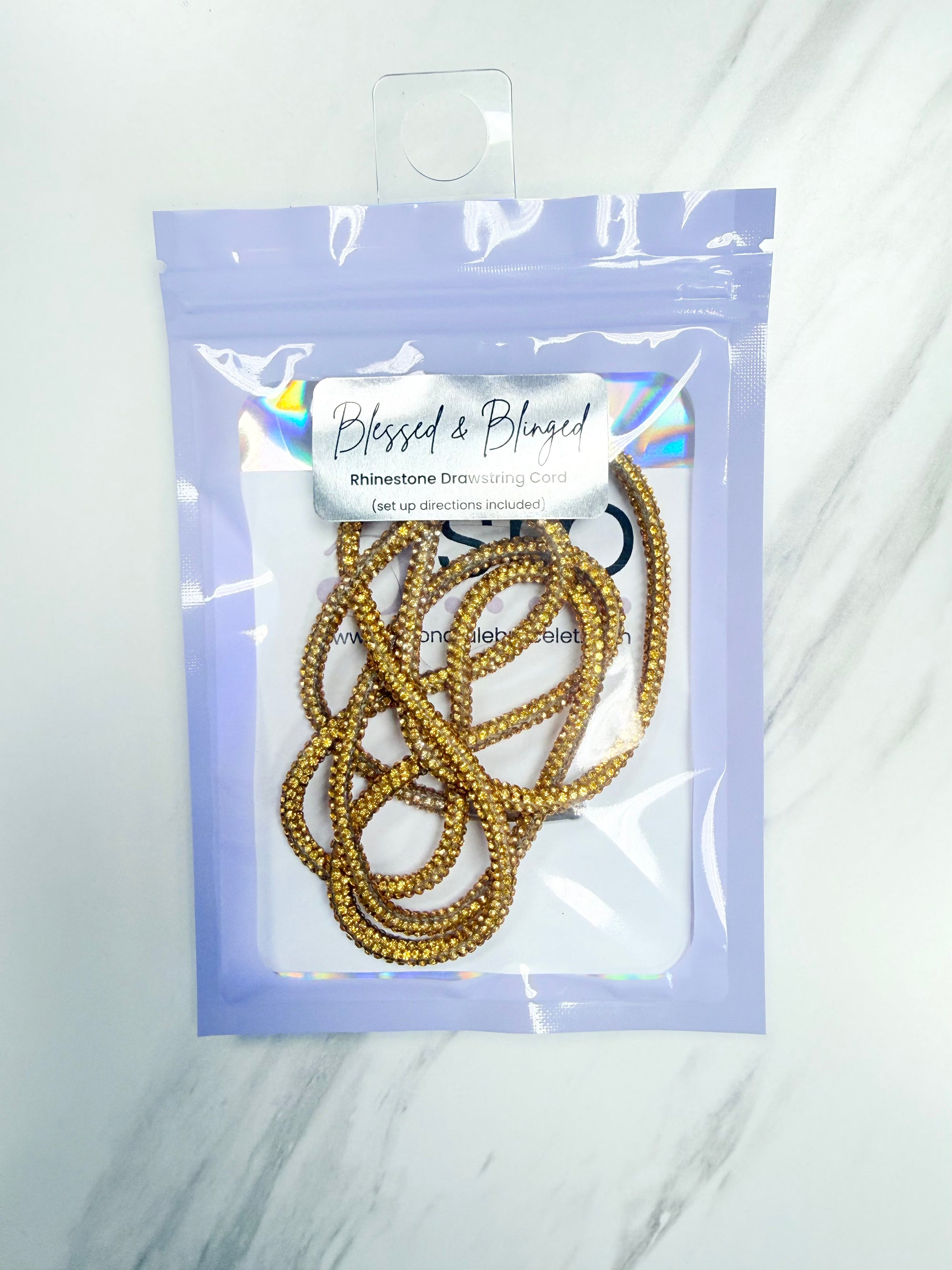 Gold Rhinestone Cord with a 'Blessed & Binged' label on a white background