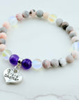 Beaded bracelet with a heart-shaped 'Grand Daughter' charm on a light background