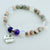 Stones bracelet with 'Grandma' charm on a white background