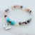 Beaded bracelet with a 'Grandma' charm on a light background