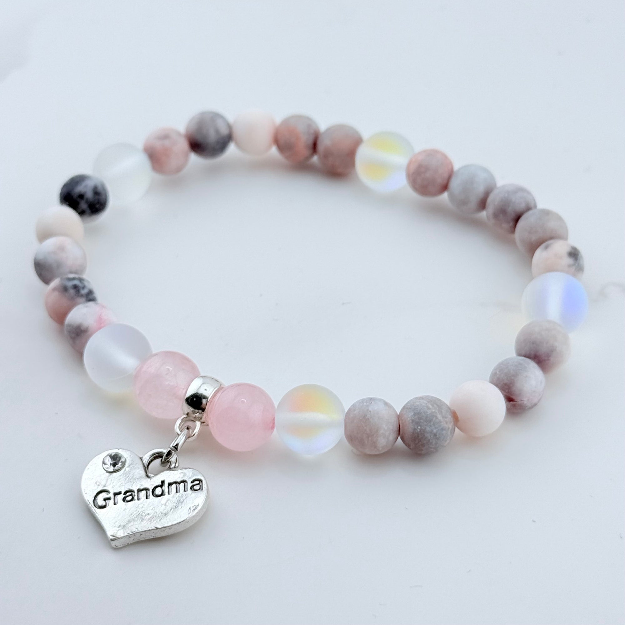 Beaded bracelet with a 'Grandma' charm on a light background