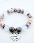 Marble beaded bracelet with a heart-shaped charm on a white background