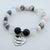 Bracelet with beads and a heart-shaped charm on a white background