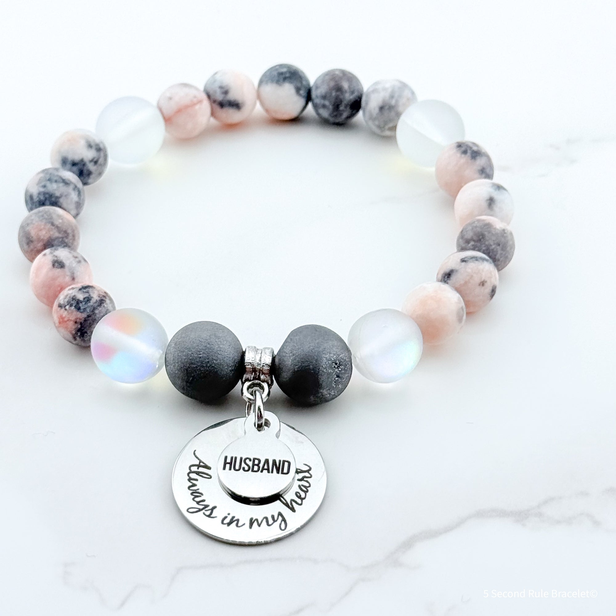 Beaded bracelet with a charm that reads 'Husband Always in My Heart' on a white background