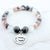 Beaded bracelet with a charm that reads 'Husband Always in My Heart' on a white background
