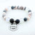 Bracelet with beads and a charm that reads 'Husband always in my heart' on a white background