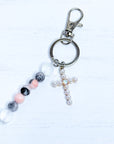 Keychain with beads and a cross charm on a white background