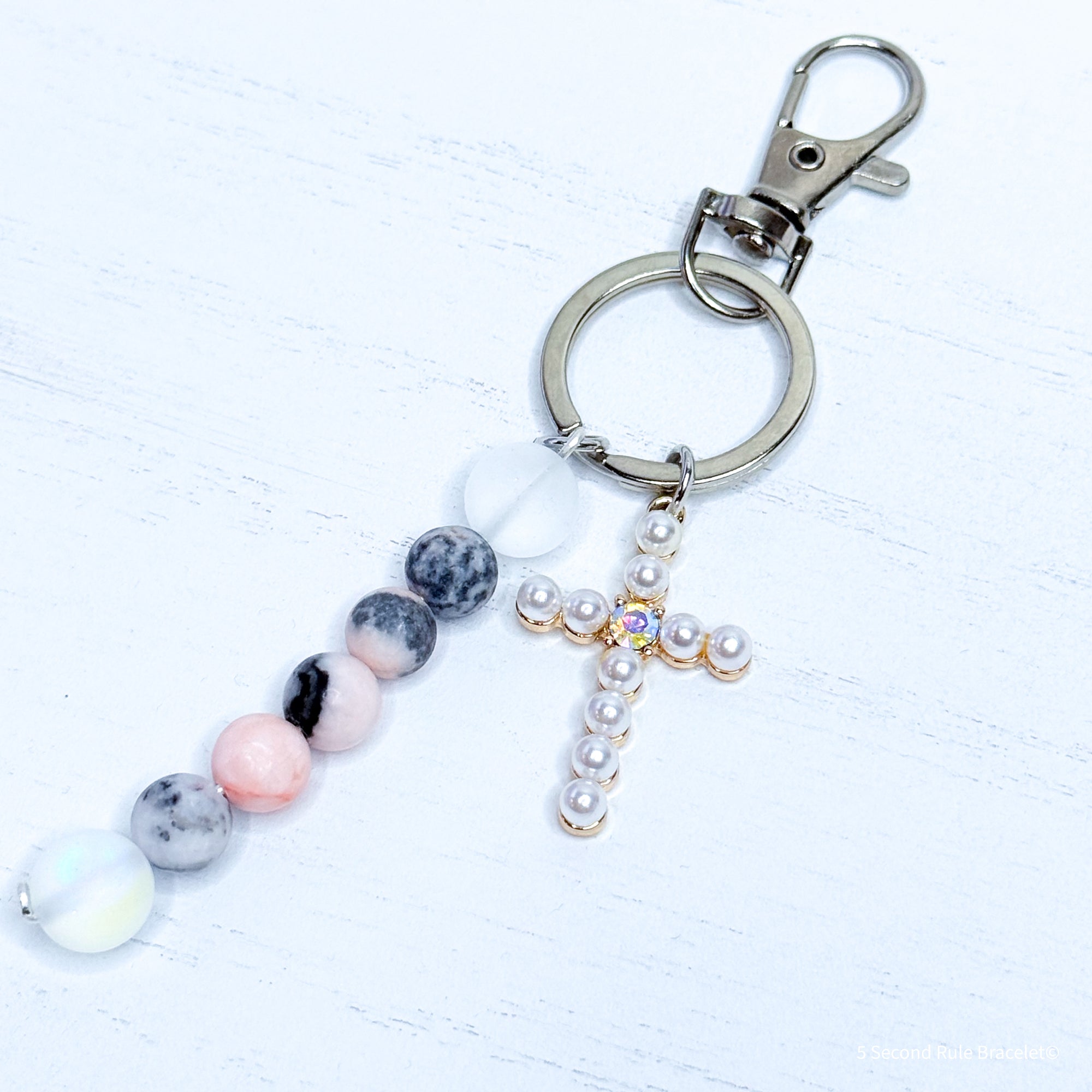 Keychain with beads and a cross charm on a white background