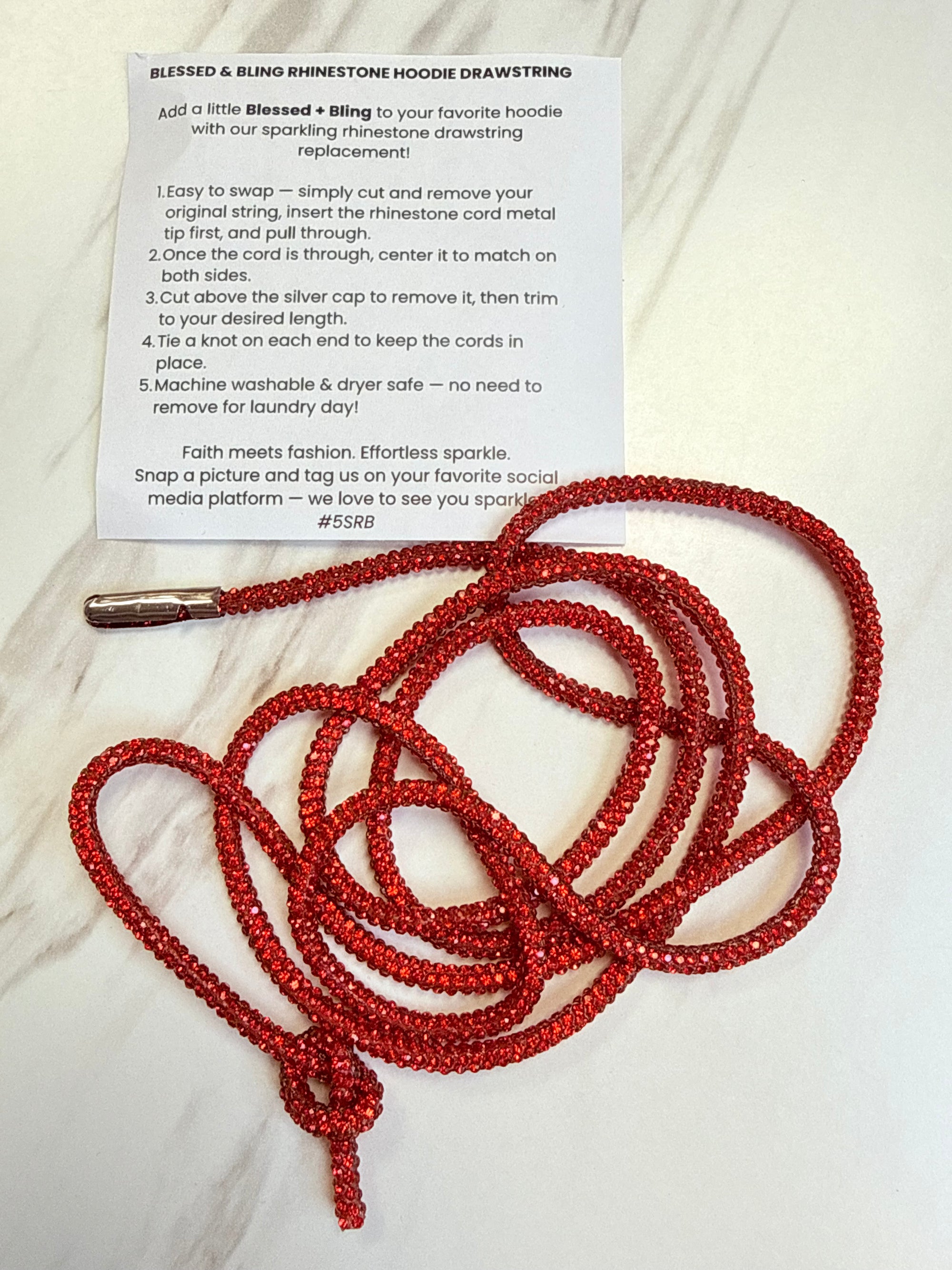 Red beaded lanyard on a white surface with text