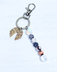 Keychain with fortune cookie charm and beaded extension on a white background