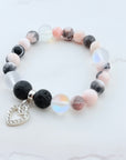 Bracelet with multicolored beads and a heart charm on a light background