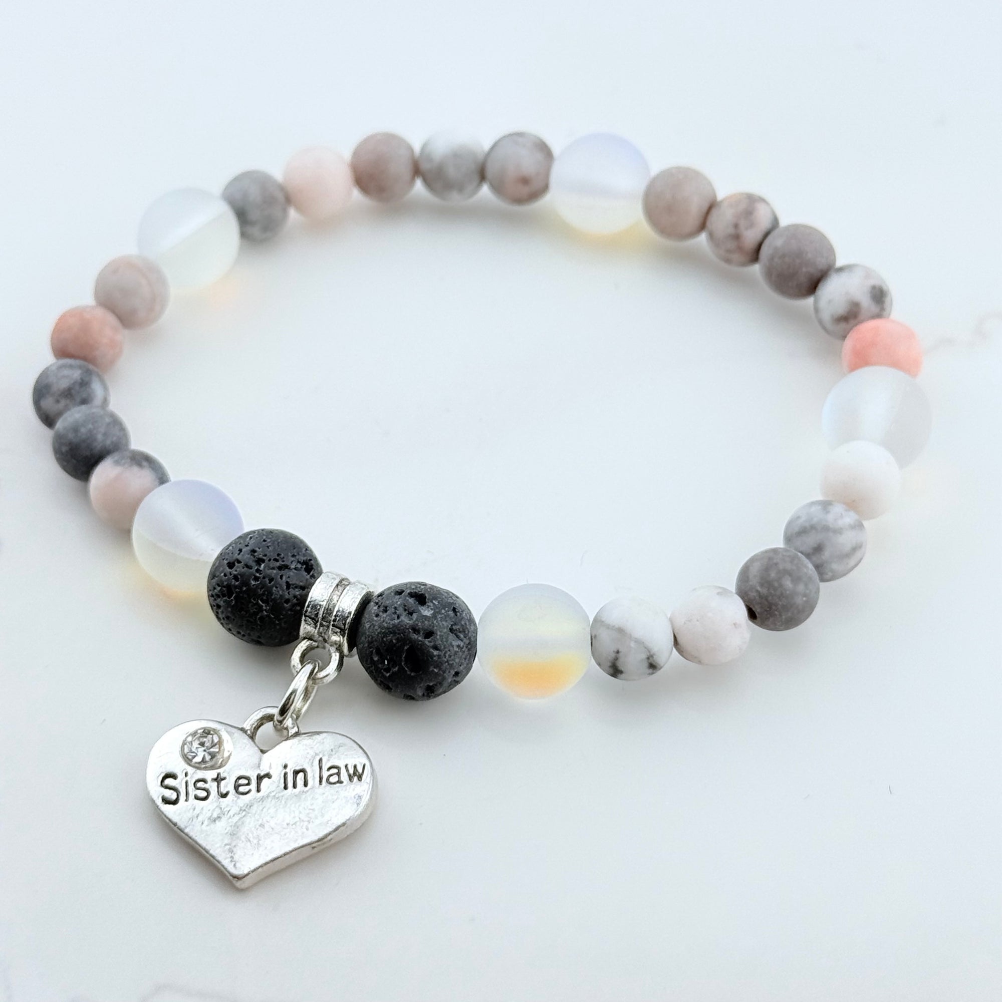 Beaded bracelet with a heart-shaped 'Sister in Law' charm on a light background