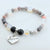 Beaded bracelet with a heart-shaped 'Sister in Law' charm on a light background