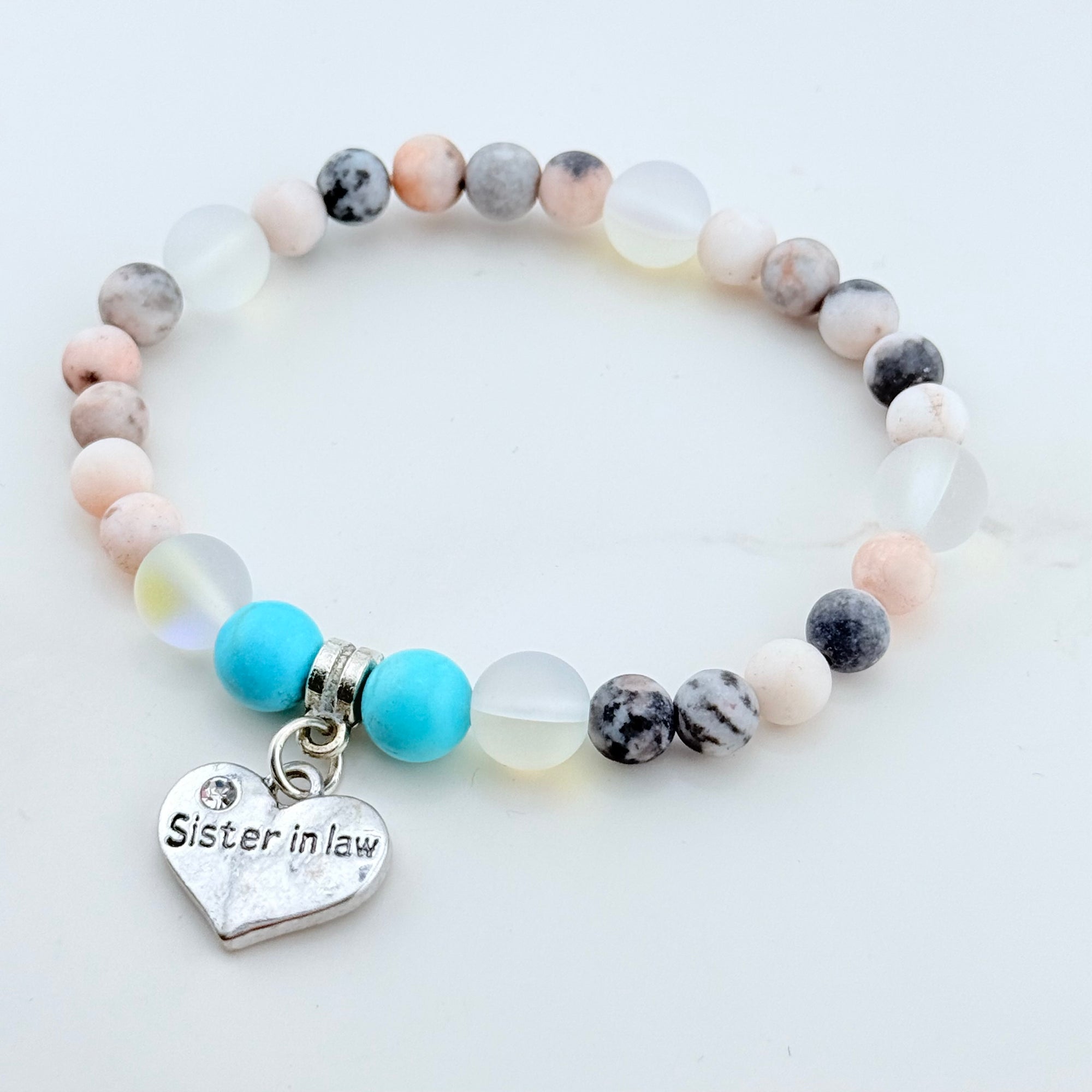 Beaded bracelet with a heart-shaped 'Sister in Law' charm on a light background