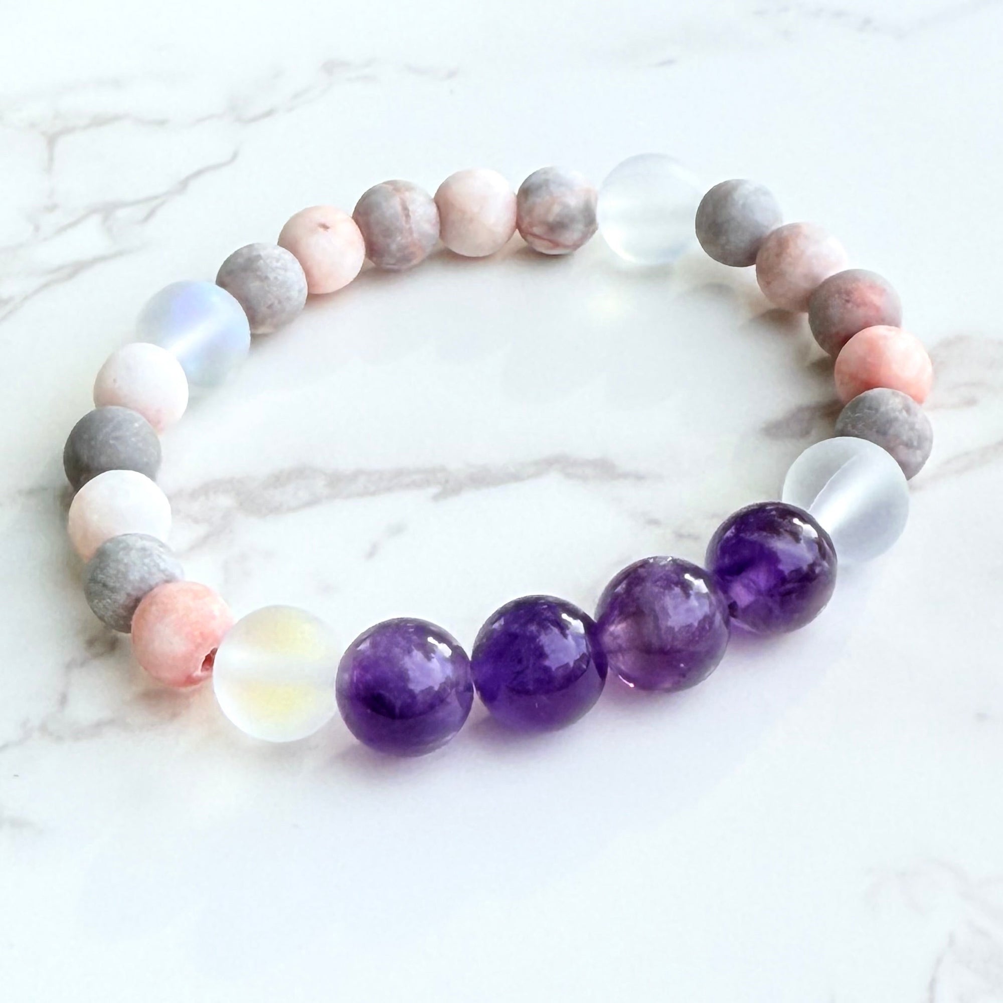 Multicolored beaded bracelet on a marble surface