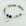 Beaded bracelet with a heart-shaped 'Sister in law' charm on a light background