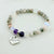 Beaded bracelet with a heart-shaped 'Sister in law' charm on a light background
