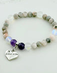 Beaded bracelet with a heart-shaped 'Sister in law' charm on a light background